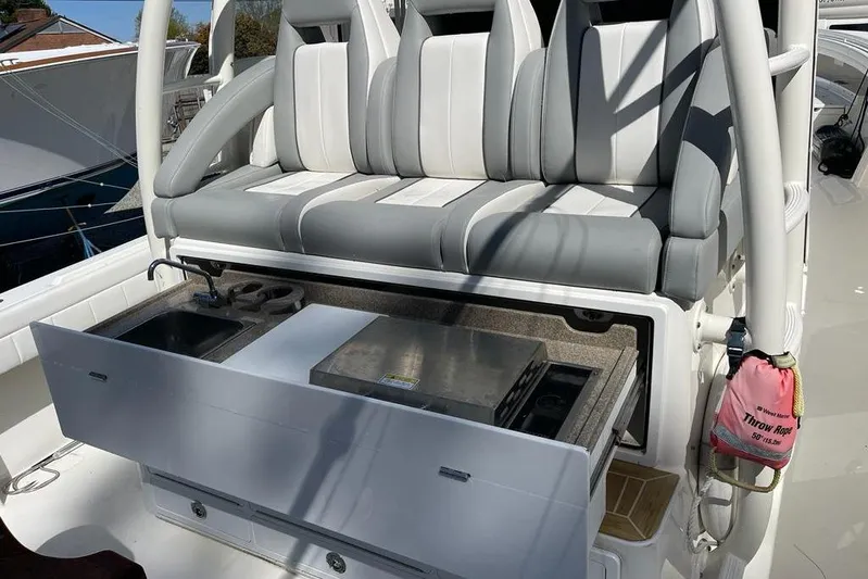  Yacht Photos Pics 2019 Regulator 41 boat with seating and integrated kitchenette, featuring sink and storage.