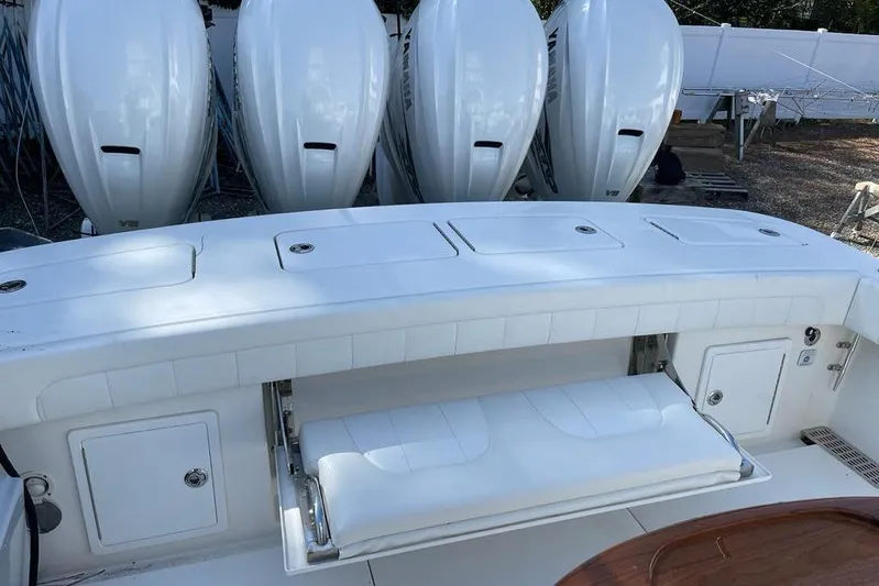 Yacht Photos Pics 2019 Regulator 41 boat with multiple outboard engines and white seating area.