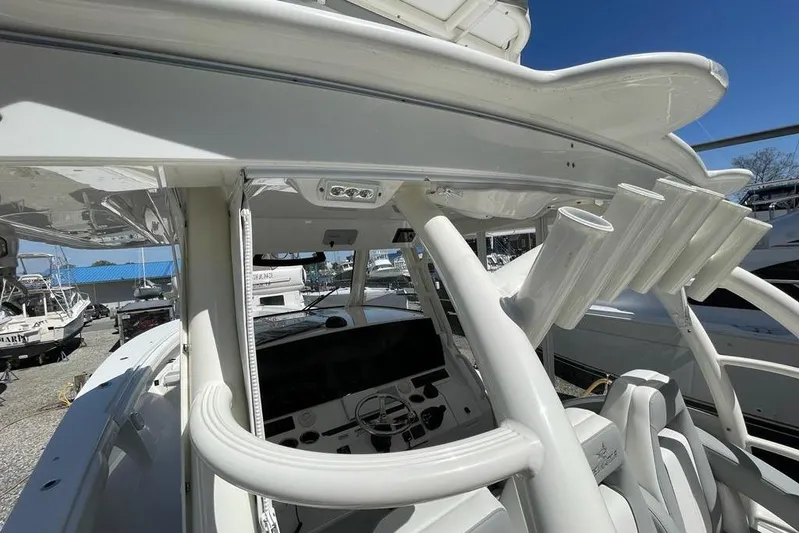  Yacht Photos Pics 2019 Regulator 41 boat interior with helm, rod holders, and seating under clear blue sky.
