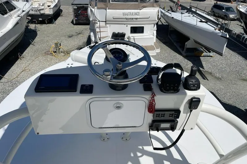  Yacht Photos Pics 2019 Regulator 41 boat helm with steering wheel, controls, and navigation equipment.