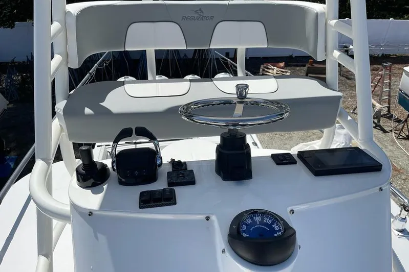  Yacht Photos Pics 2019 Regulator 41 boat helm with steering wheel and navigation instruments.