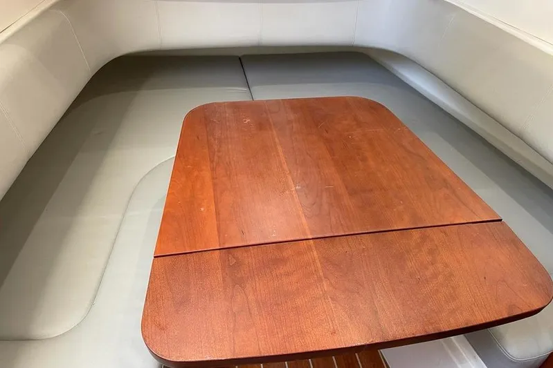  Yacht Photos Pics 2019 Regulator 41 boat interior with wooden table and cushioned seating.