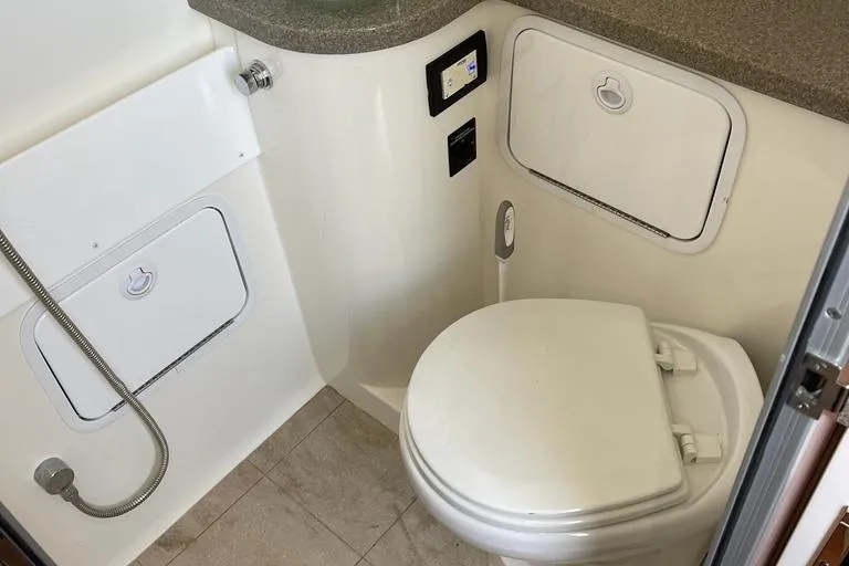  Yacht Photos Pics 2019 Regulator 41 boat bathroom with toilet, shower, and storage compartments.