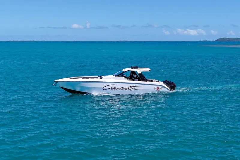  Yacht Photos Pics 2025 Cigarette 42 Auroris speedboat cruising on clear blue ocean waters.