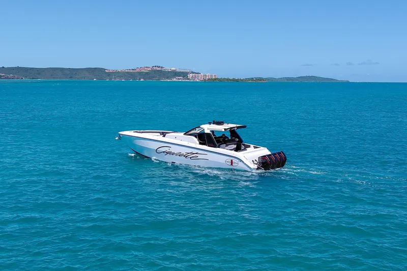  Yacht Photos Pics 2025 Cigarette 42 Auroris boat cruising on clear blue ocean waters.