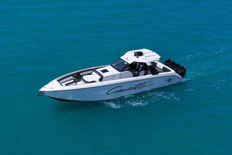  Yacht Photos Pics 2025 Cigarette 42 Auroris speedboat cruising on clear blue water.