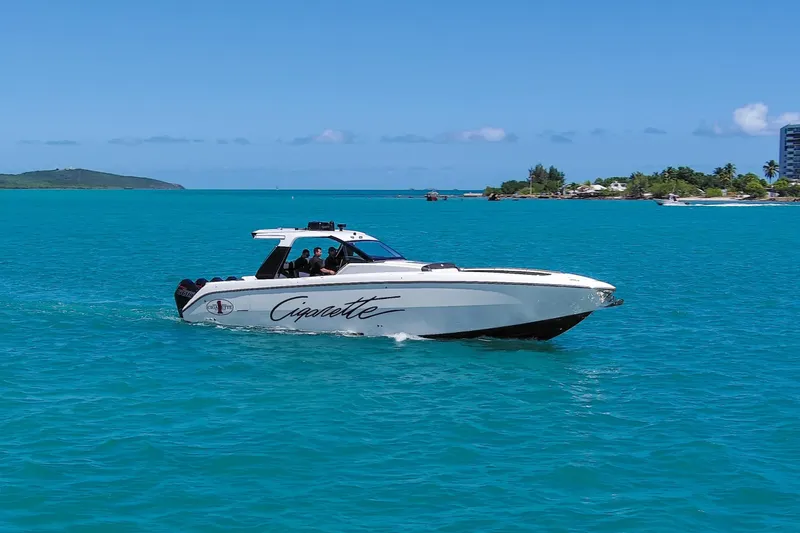  Yacht Photos Pics 2025 Cigarette 42 Auroris boat cruising on turquoise waters near a tropical island.