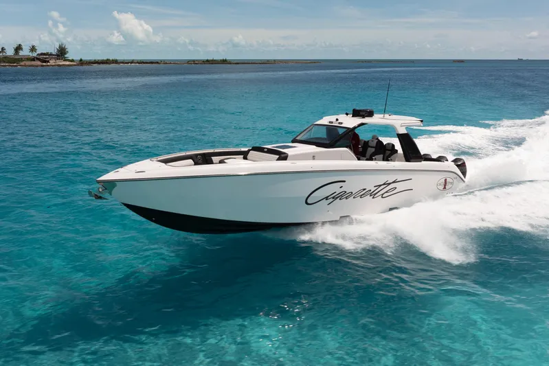  Yacht Photos Pics 2025 Cigarette 42 Auroris speedboat cruising on clear blue ocean waters.