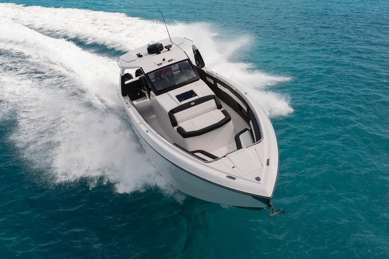  Yacht Photos Pics 2025 Cigarette 42 Auroris speedboat cruising on clear blue water.