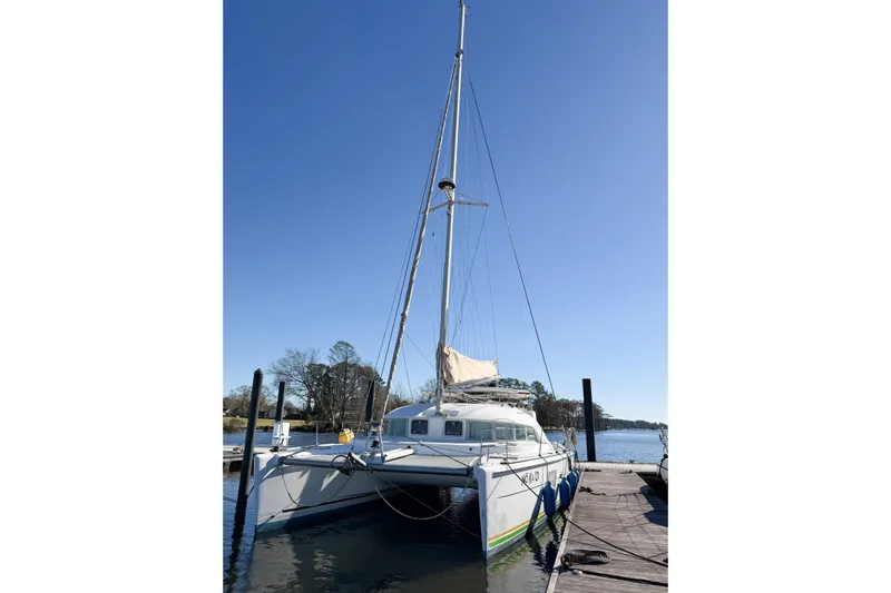 No Ka Oi Yacht Photos Pics 2005 Lagoon 380 S2 catamaran docked under clear blue sky.