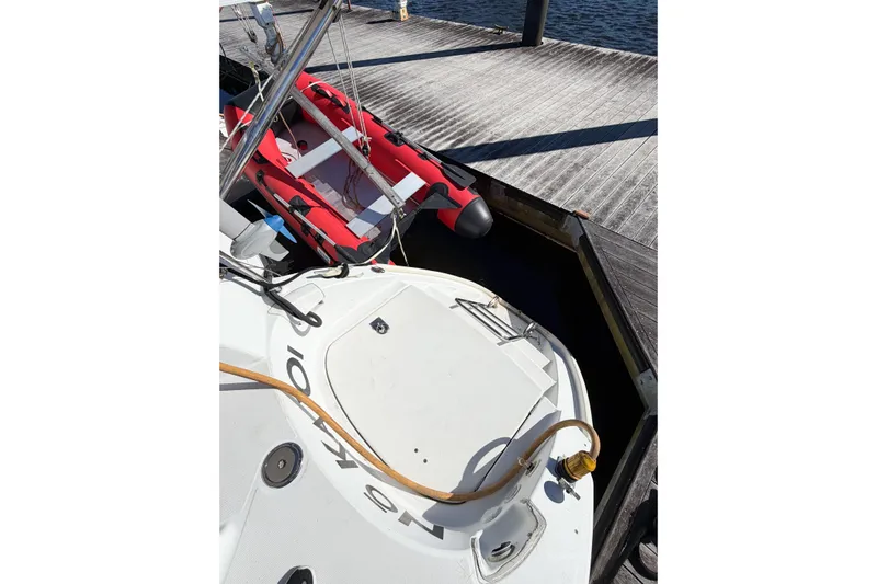 No Ka Oi Yacht Photos Pics 2005 Lagoon 380 S2 catamaran docked with red inflatable boat nearby.