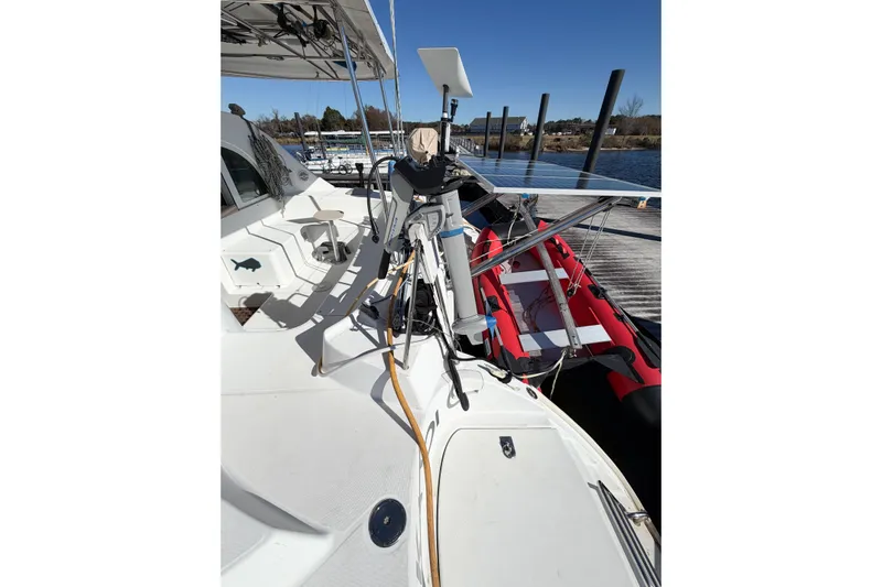 No Ka Oi Yacht Photos Pics 2005 Lagoon 380 S2 catamaran deck with equipment and docked inflatable boat.