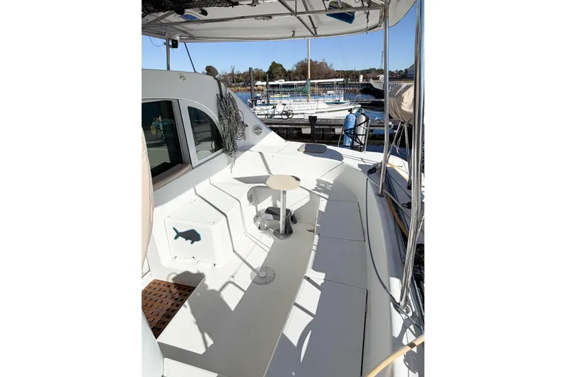 No Ka Oi Yacht Photos Pics 2005 Lagoon 380 S2 catamaran deck with seating and marina view.