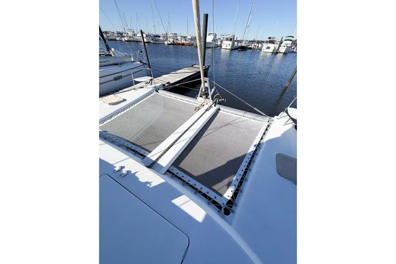 No Ka Oi Yacht Photos Pics 2005 Lagoon 380 S2 catamaran docked at marina, featuring netted deck area.