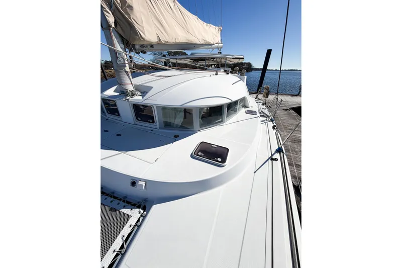 No Ka Oi Yacht Photos Pics 2005 Lagoon 380 S2 catamaran docked, showcasing sleek design and spacious deck.