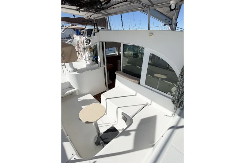 No Ka Oi Yacht Photos Pics 2005 Lagoon 380 S2 catamaran cockpit with seating and helm station.