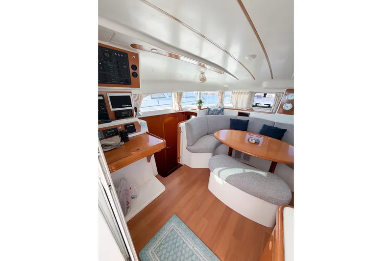 No Ka Oi Yacht Photos Pics Interior of 2005 Lagoon 380 S2 catamaran with cozy seating and navigation equipment.