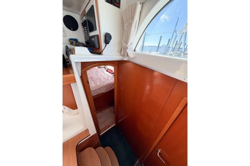 No Ka Oi Yacht Photos Pics Interior of 2005 Lagoon 380 S2 catamaran with wood paneling and cabin view.