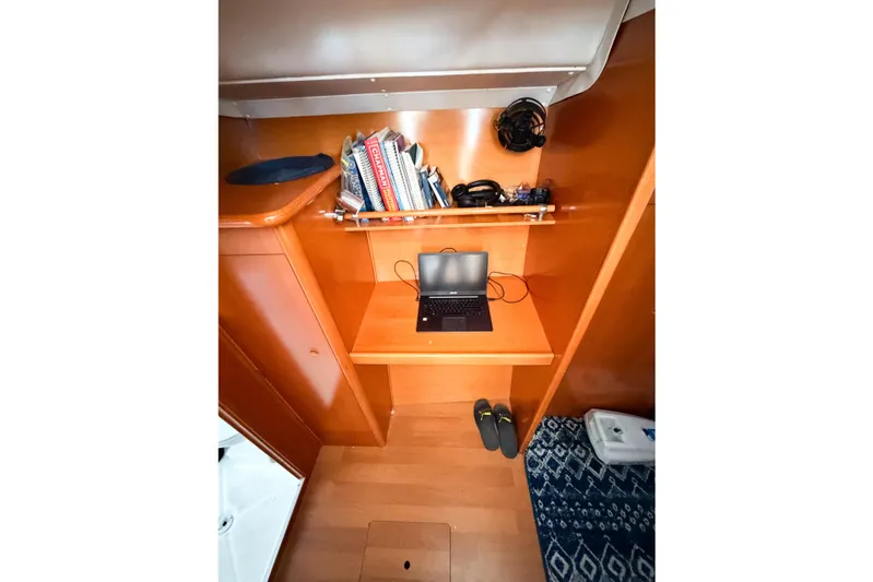 No Ka Oi Yacht Photos Pics Interior of 2005 Lagoon 380 S2 yacht with laptop, books, and shoes.