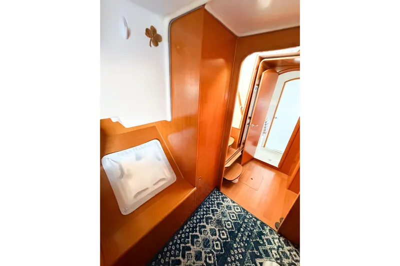 No Ka Oi Yacht Photos Pics Interior of 2005 Lagoon 380 S2 yacht with wooden finish and patterned carpet.