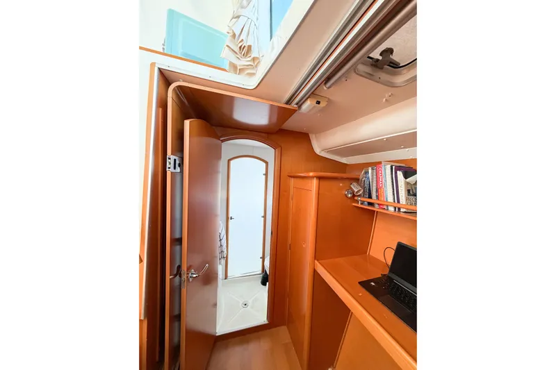 No Ka Oi Yacht Photos Pics Interior of 2005 Lagoon 380 S2 yacht with wooden cabinetry and bookshelves.