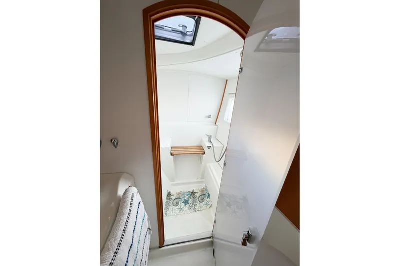 No Ka Oi Yacht Photos Pics Interior of 2005 Lagoon 380 S2 yacht bathroom with shower and skylight.