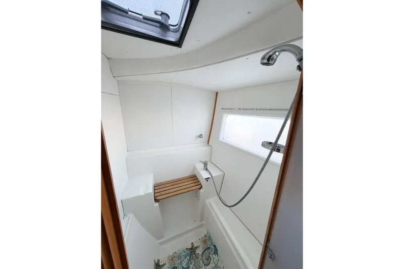 No Ka Oi Yacht Photos Pics Bathroom interior of 2005 Lagoon 380 S2 yacht with shower and window.