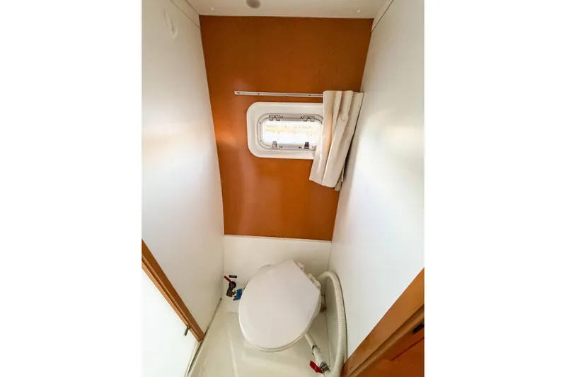 No Ka Oi Yacht Photos Pics 2005 Lagoon 380 S2 yacht bathroom with window and compact toilet.