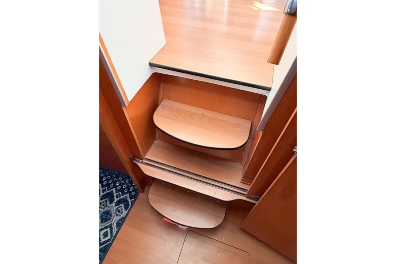 No Ka Oi Yacht Photos Pics Wooden interior stairs of a 2005 Lagoon 380 S2 catamaran.