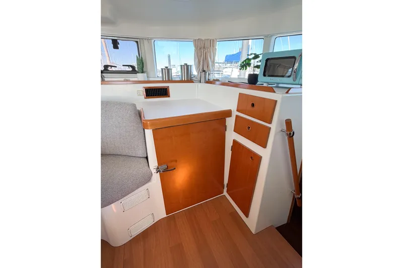No Ka Oi Yacht Photos Pics Interior of 2005 Lagoon 380 S2 yacht with wooden cabinetry and seating area.