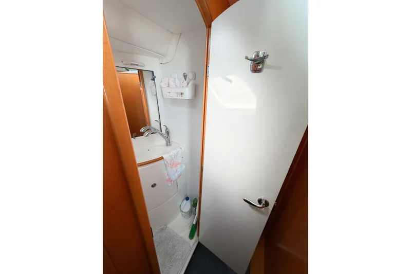 No Ka Oi Yacht Photos Pics Compact bathroom in 2005 Lagoon 380 S2 yacht, featuring sink and storage.