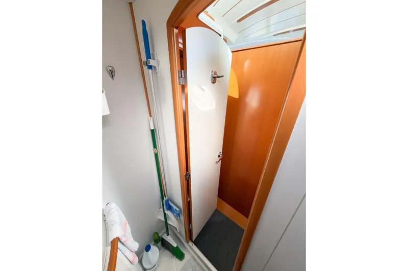 No Ka Oi Yacht Photos Pics Interior of 2005 Lagoon 380 S2 yacht showing a compact storage area with cleaning supplies.