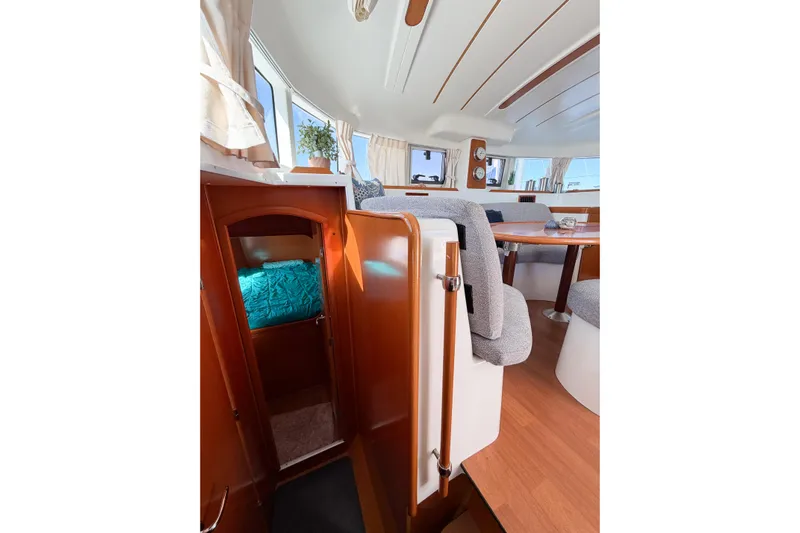No Ka Oi Yacht Photos Pics Interior of 2005 Lagoon 380 S2 catamaran with cozy seating and wooden finishes.