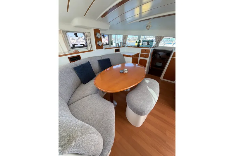 No Ka Oi Yacht Photos Pics Interior of 2005 Lagoon 380 S2 catamaran with cozy seating and dining area.