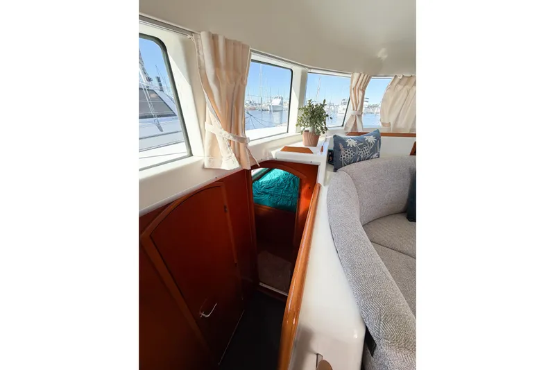 No Ka Oi Yacht Photos Pics Interior of 2005 Lagoon 380 S2 catamaran with cozy seating and nautical decor.