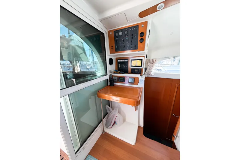 No Ka Oi Yacht Photos Pics Control panel of a 2005 Lagoon 380 S2 catamaran with navigation equipment.