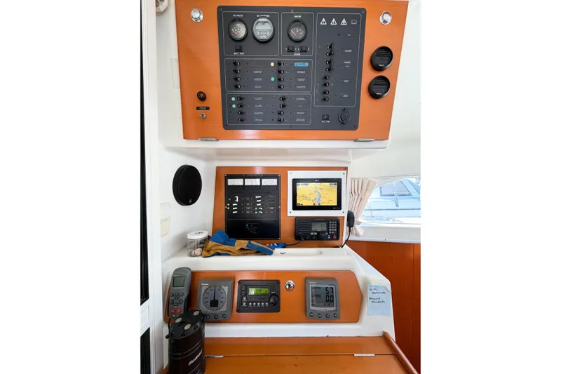 No Ka Oi Yacht Photos Pics Control panel of a 2005 Lagoon 380 S2 catamaran with navigation equipment.