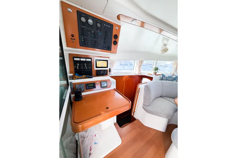 No Ka Oi Yacht Photos Pics Interior of 2005 Lagoon 380 S2 yacht with navigation panel and seating area.