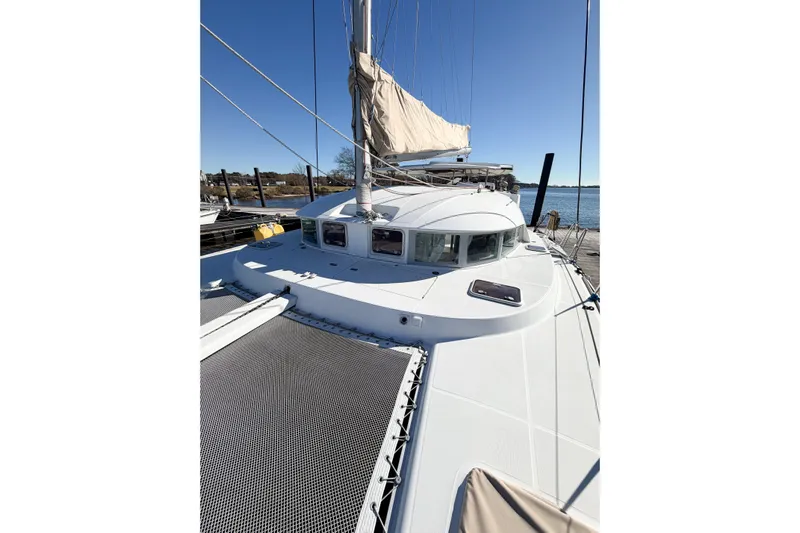 No Ka Oi Yacht Photos Pics 2005 Lagoon 380 S2 catamaran docked, showcasing sleek design and spacious deck.