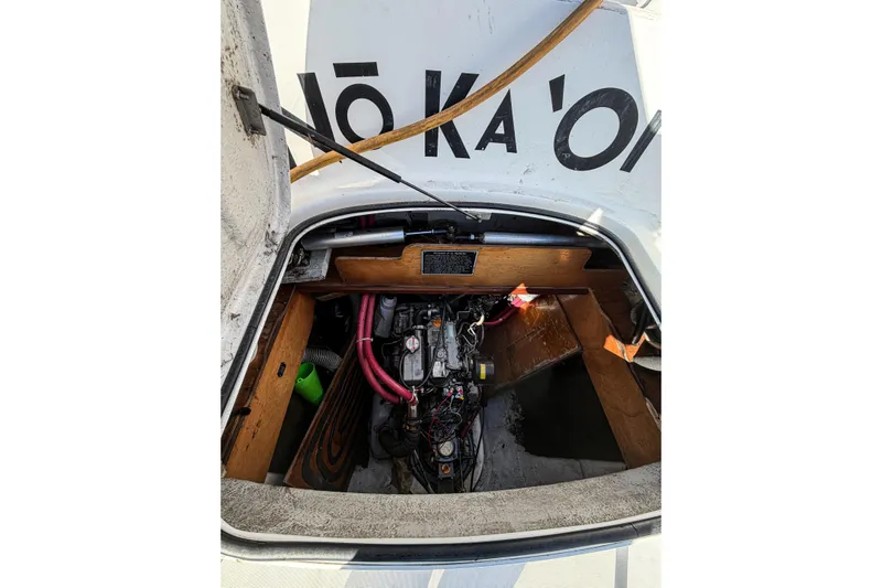 No Ka Oi Yacht Photos Pics Engine compartment of a 2005 Lagoon 380 S2 catamaran, showing mechanical components and wiring.