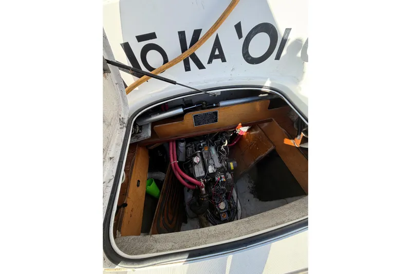 No Ka Oi Yacht Photos Pics Engine compartment of a 2005 Lagoon 380 S2 catamaran with visible mechanical components.