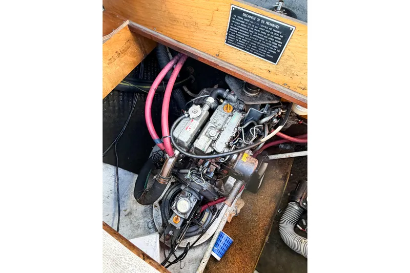 No Ka Oi Yacht Photos Pics Engine compartment of a 2005 Lagoon 380 S2 catamaran with visible wiring and components.