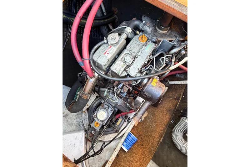 No Ka Oi Yacht Photos Pics Engine compartment of a 2005 Lagoon 380 S2 catamaran with visible hoses and components.