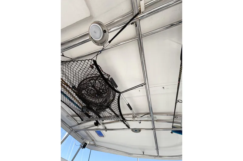 No Ka Oi Yacht Photos Pics Ceiling view of 2005 Lagoon 380 S2 catamaran with fishing gear and net storage.