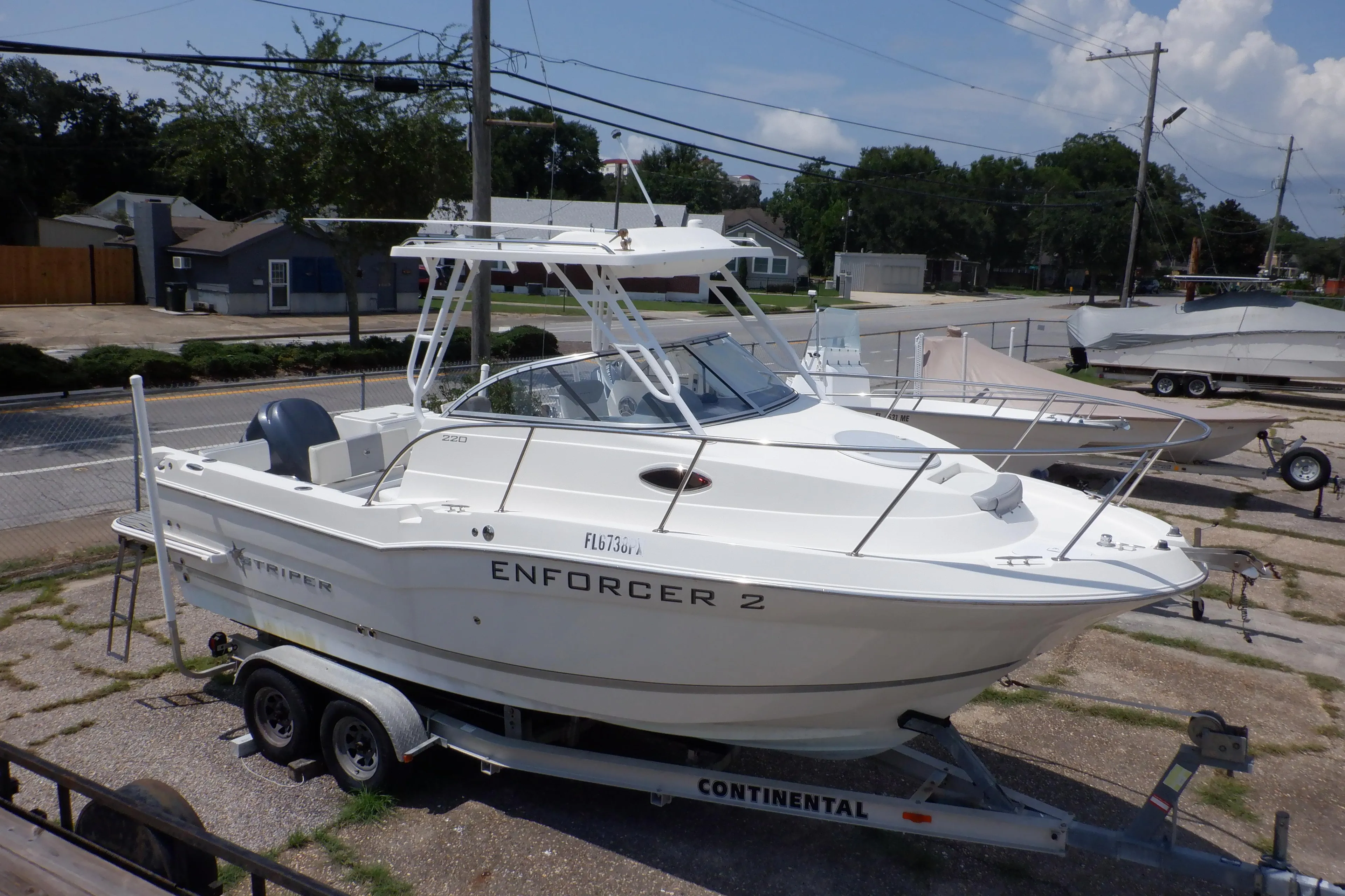 2015 Seaswirl Striper 220 Walkaround boat on trailer, parked outdoors.