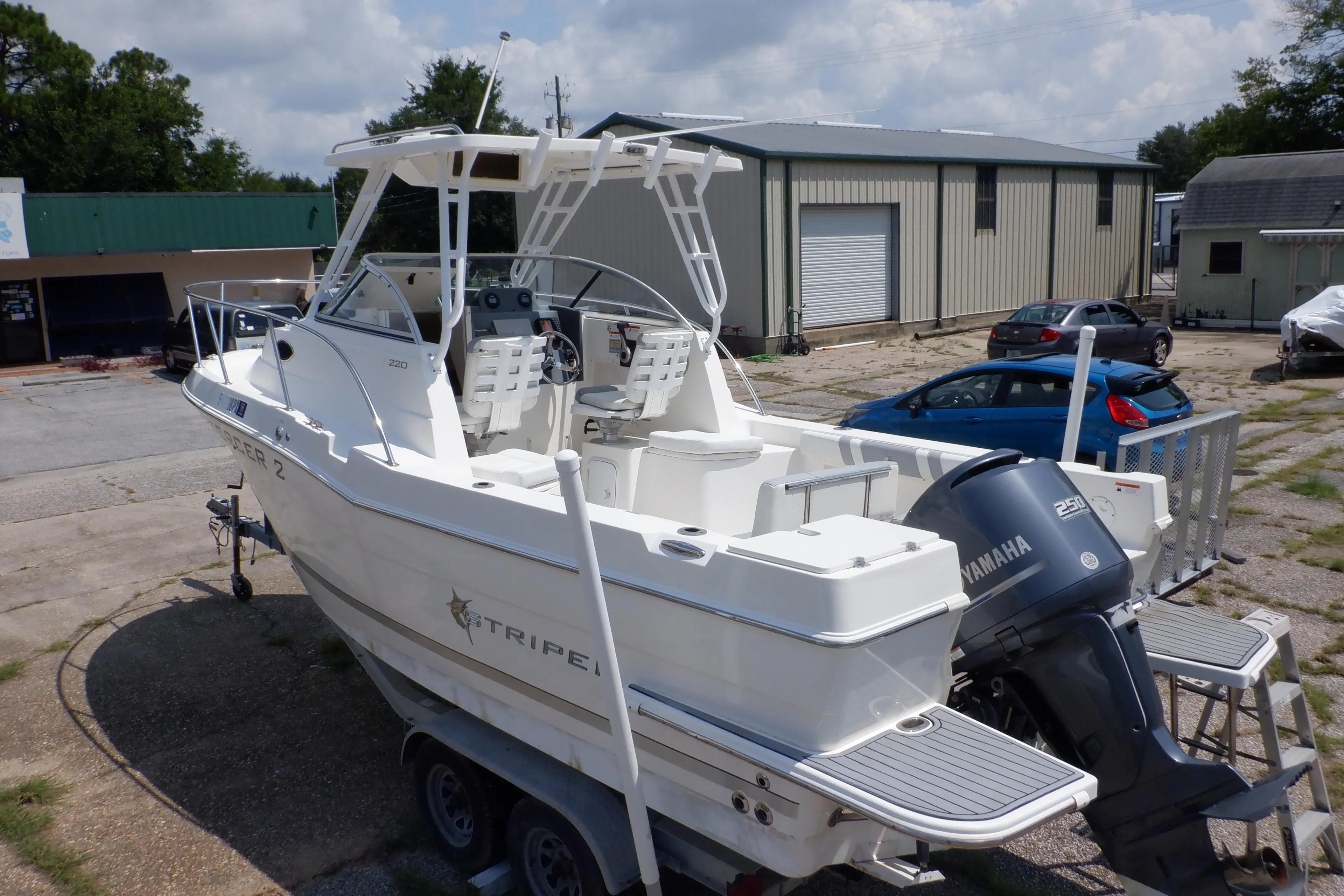 2015 Seaswirl Striper 220 Walkaround boat with Yamaha engine on trailer.