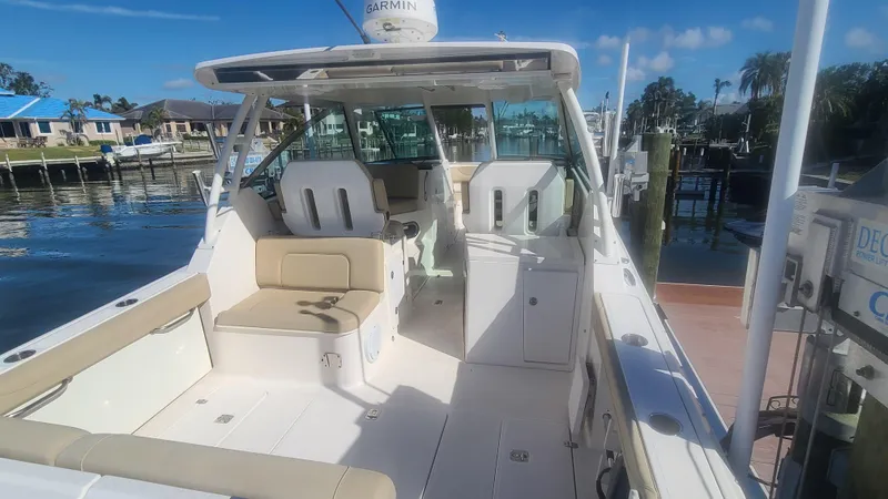  Yacht Photos Pics 2016 Pursuit DC 325 Dual Console boat docked, featuring spacious seating and modern design.