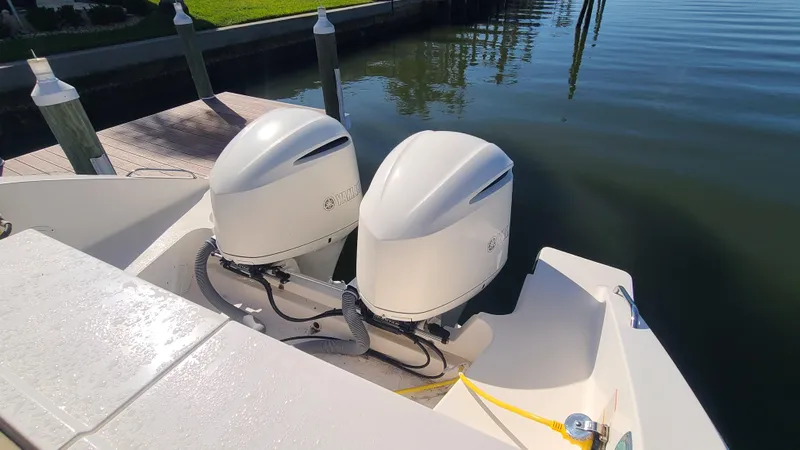  Yacht Photos Pics 2016 Pursuit DC 325 Dual Console with twin outboard engines docked by the water.