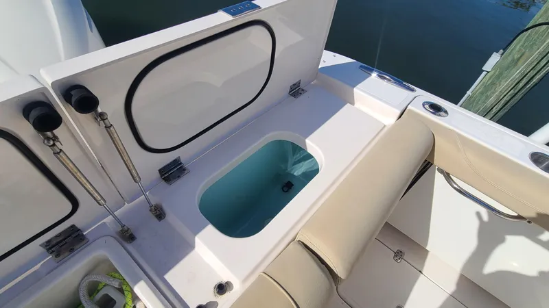  Yacht Photos Pics 2016 Pursuit DC 325 Dual Console boat interior with open storage compartment.
