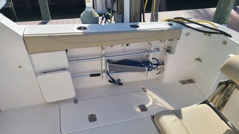  Yacht Photos Pics 2016 Pursuit DC 325 Dual Console boat interior with seating and storage compartments.
